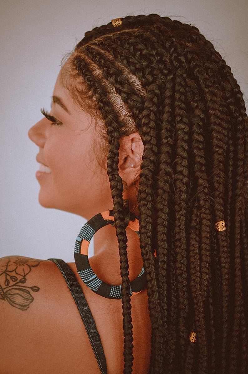 Profile of afro woman with braids smiling